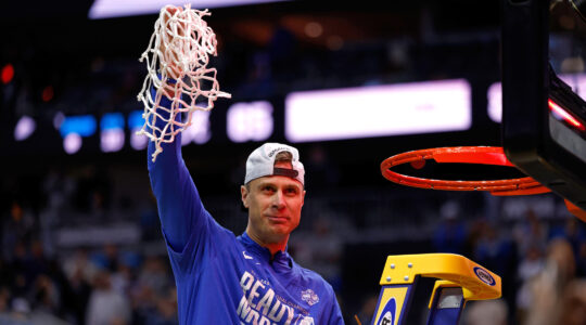 NEWARK, NEW JERSEY - MARCH 29: Head coach Jon Scheyer of the Duke Blue Devils celebrates after cutting the net following a victory against the Alabama Crimson Tide in the Elite Eight round of the men’s NCAA basketball tournament at Prudential Center on March 29, 2025 in Newark, New Jersey. (Lance King/Getty Images)
