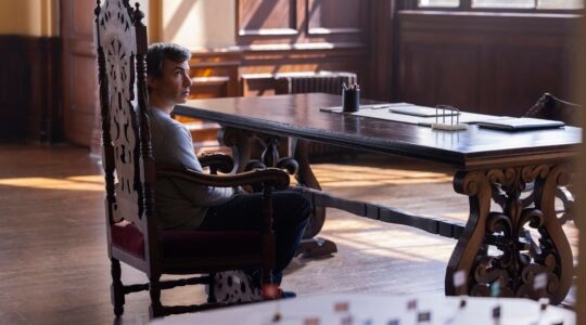 An actor in a set resembling a Nazi general's office